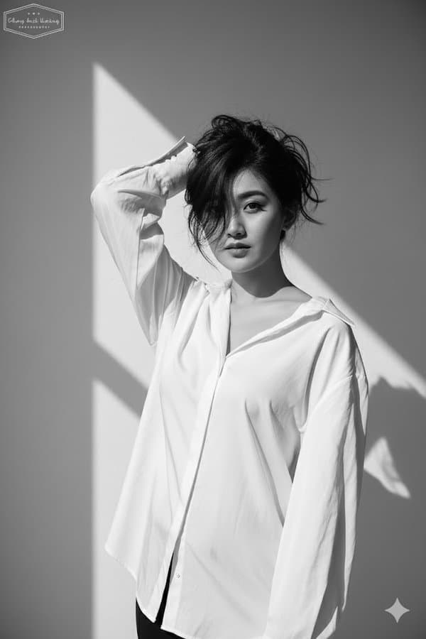 A portrait photo wearing a loose white shirt (fashion, minimalist)
